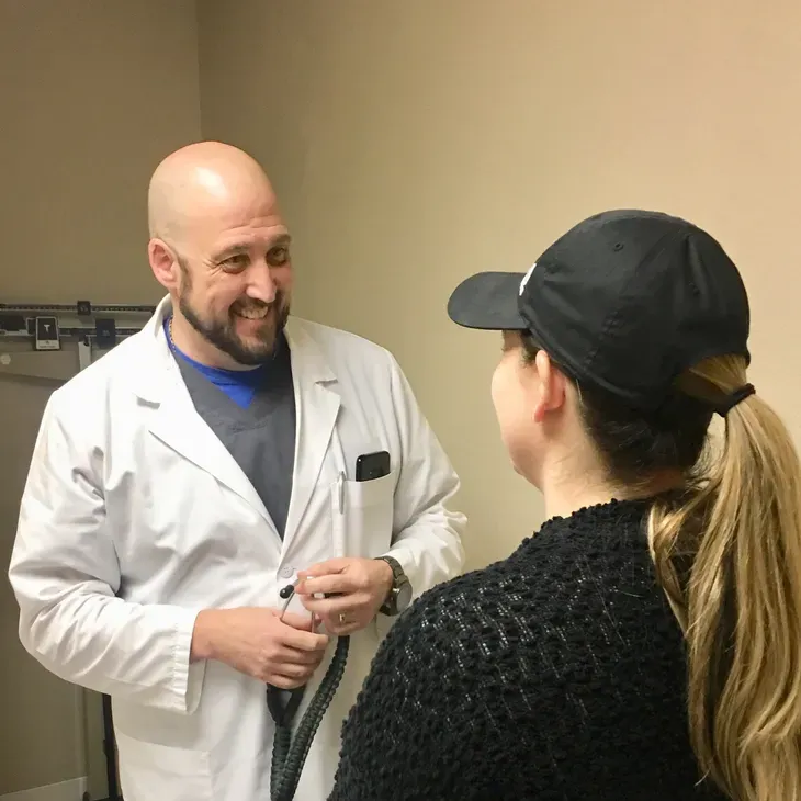 Mark Fergeson, FNP, in conversation with a patient during a primary care visit